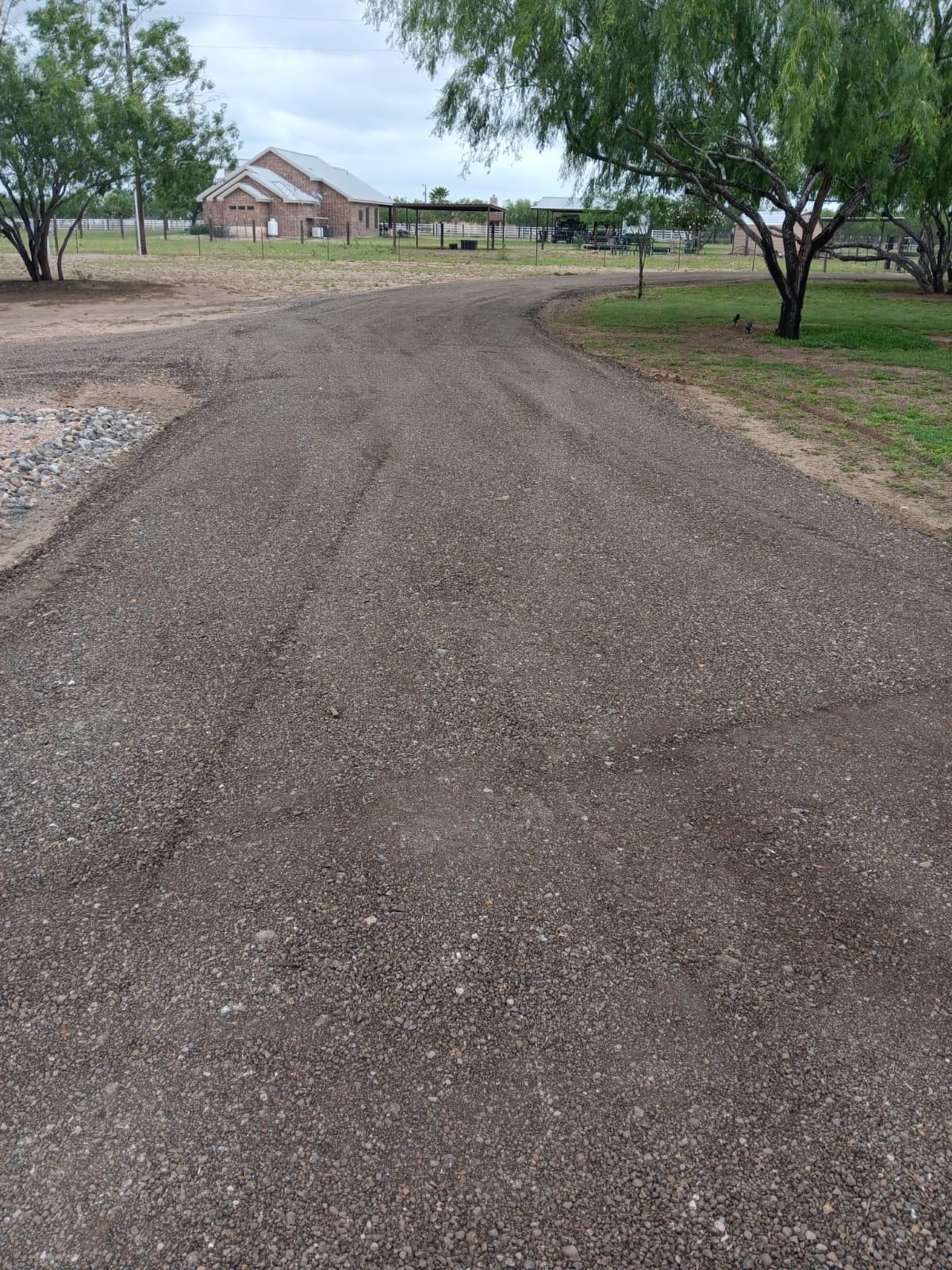 Graded dirt road through a rural property