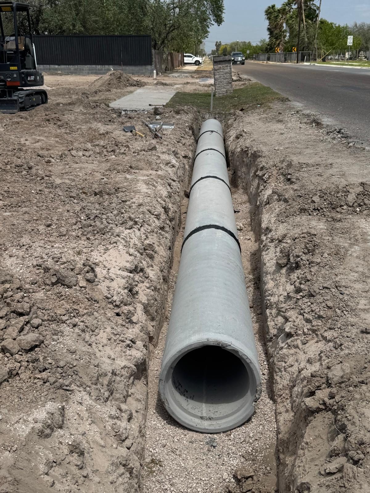 Concrete drainage pipe set in a trench