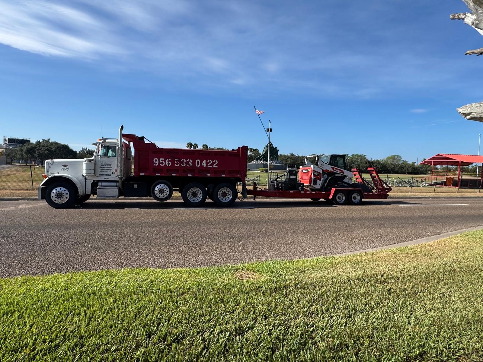 MM Agregates dump truck pulling an equipment trailer